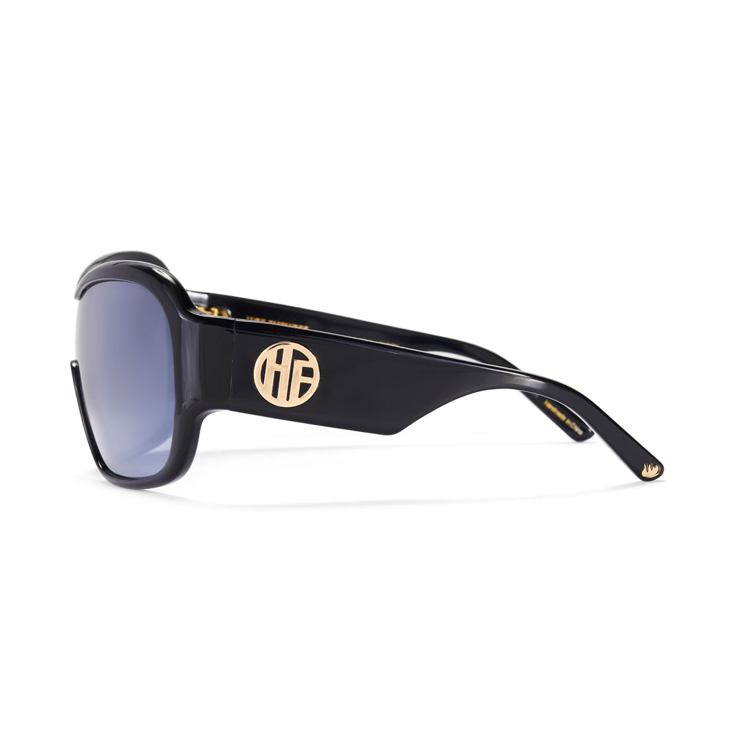 Side profile of the Hot Futures Gloss Black Wraparound Sunglasses, with the gold HF logo on the arm and the gold flame logo at the ends of each arm