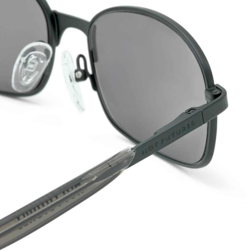 Close up of the Blaze Hot Futures sunglasses in matt black, showing the HF branding down the arms.