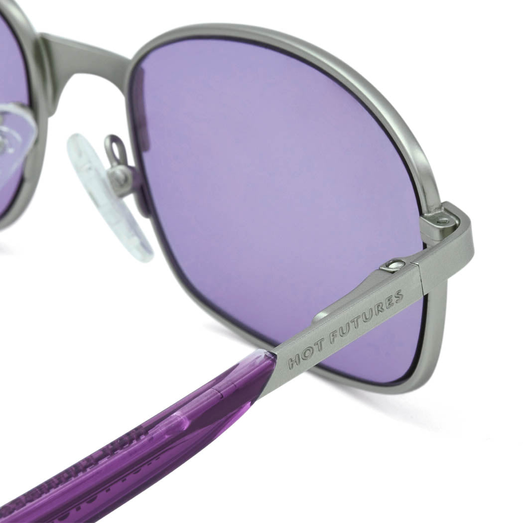 Close up of the Blaze Purple/Silver sunglasses, showing their silver frame with HF branding.