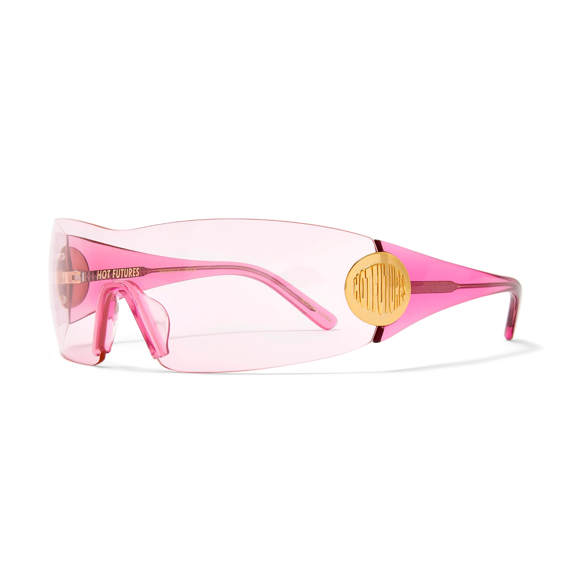 The hot pink club kid sunglasses by Hot Futures, with bright pink arms and soft pink lens, shot against a white background