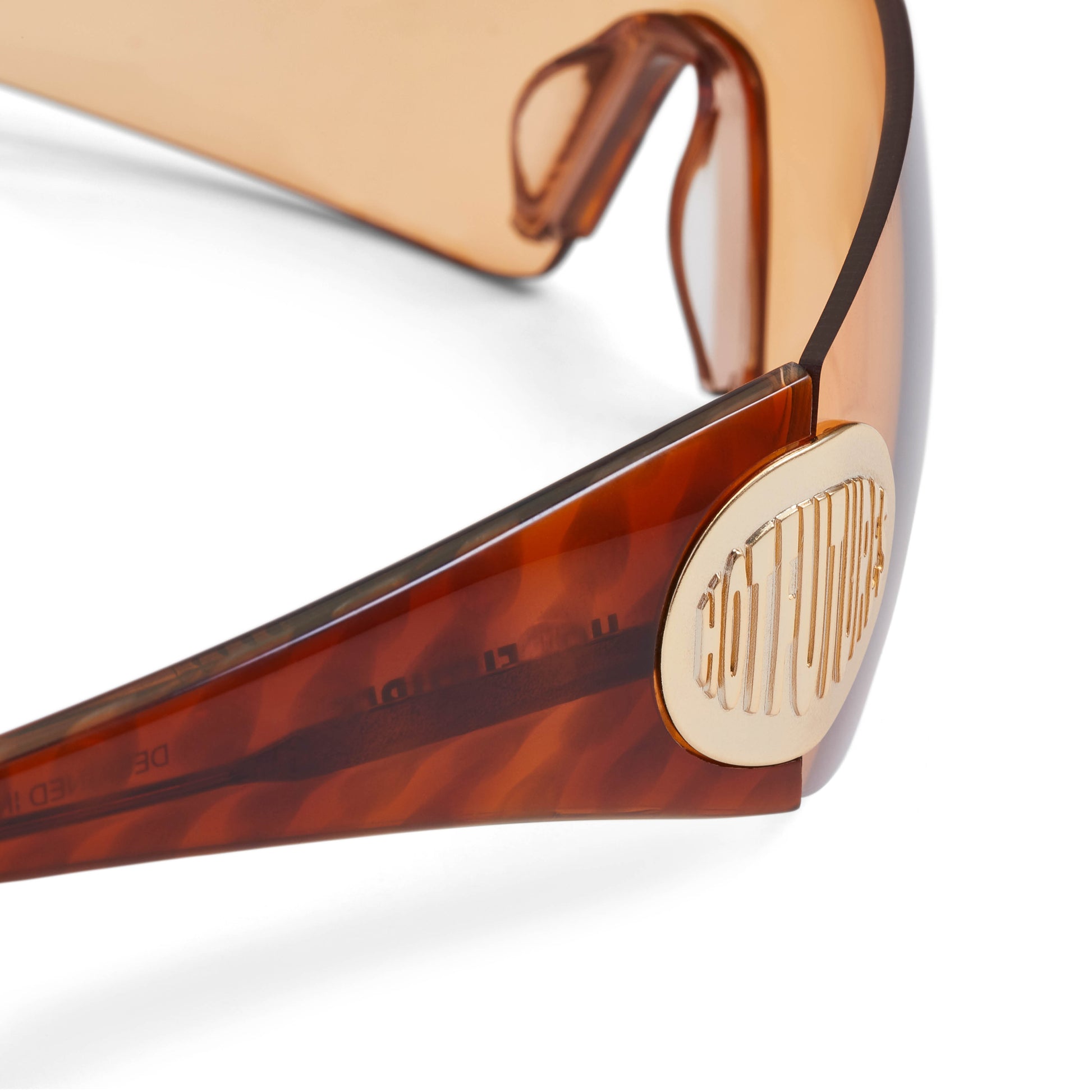 close up of club kid sunglasses with the gold Hot Futures logo