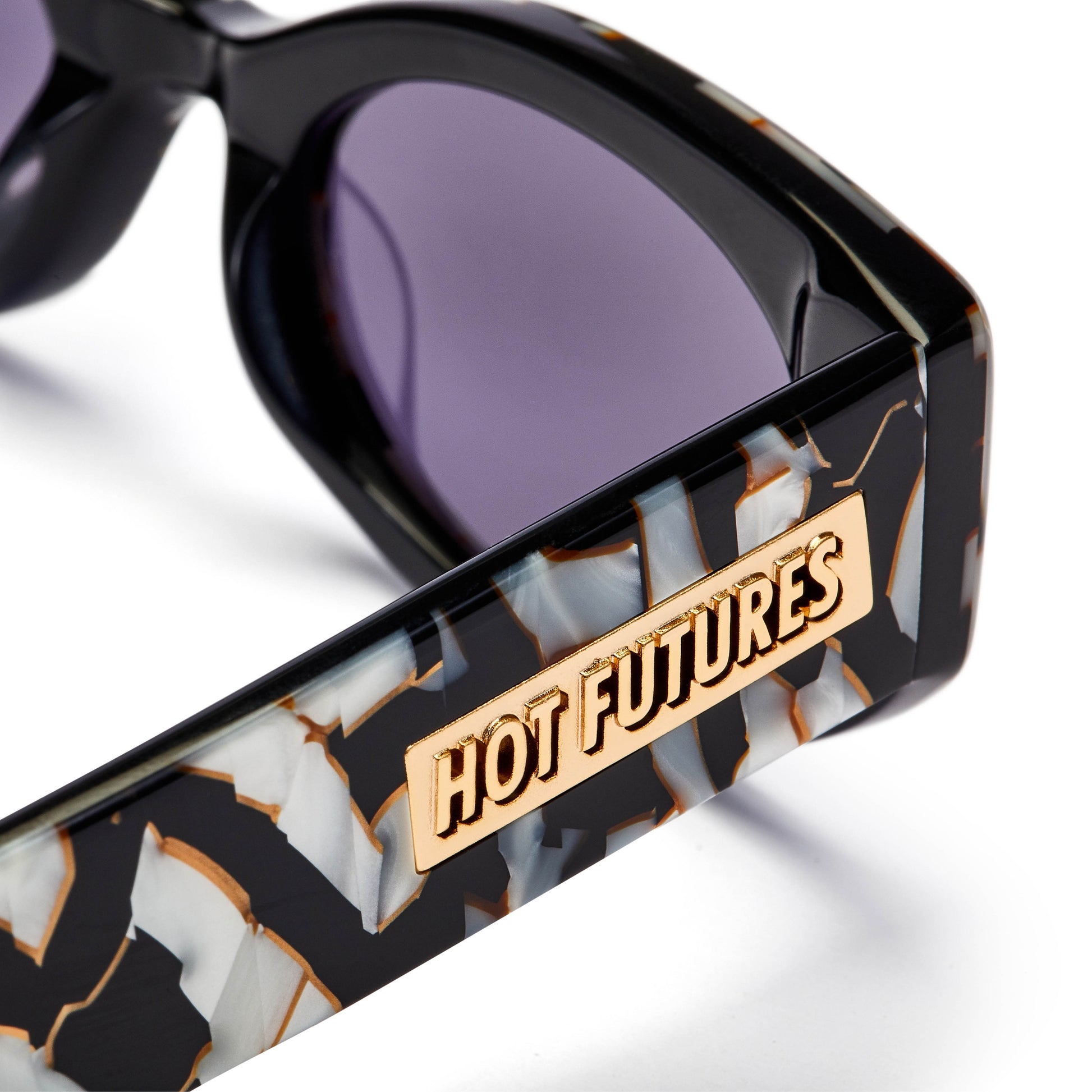 Close up shot of the mosaic pattern cosmic rebel sunglasses with the gold Hot Futures branding on the arm