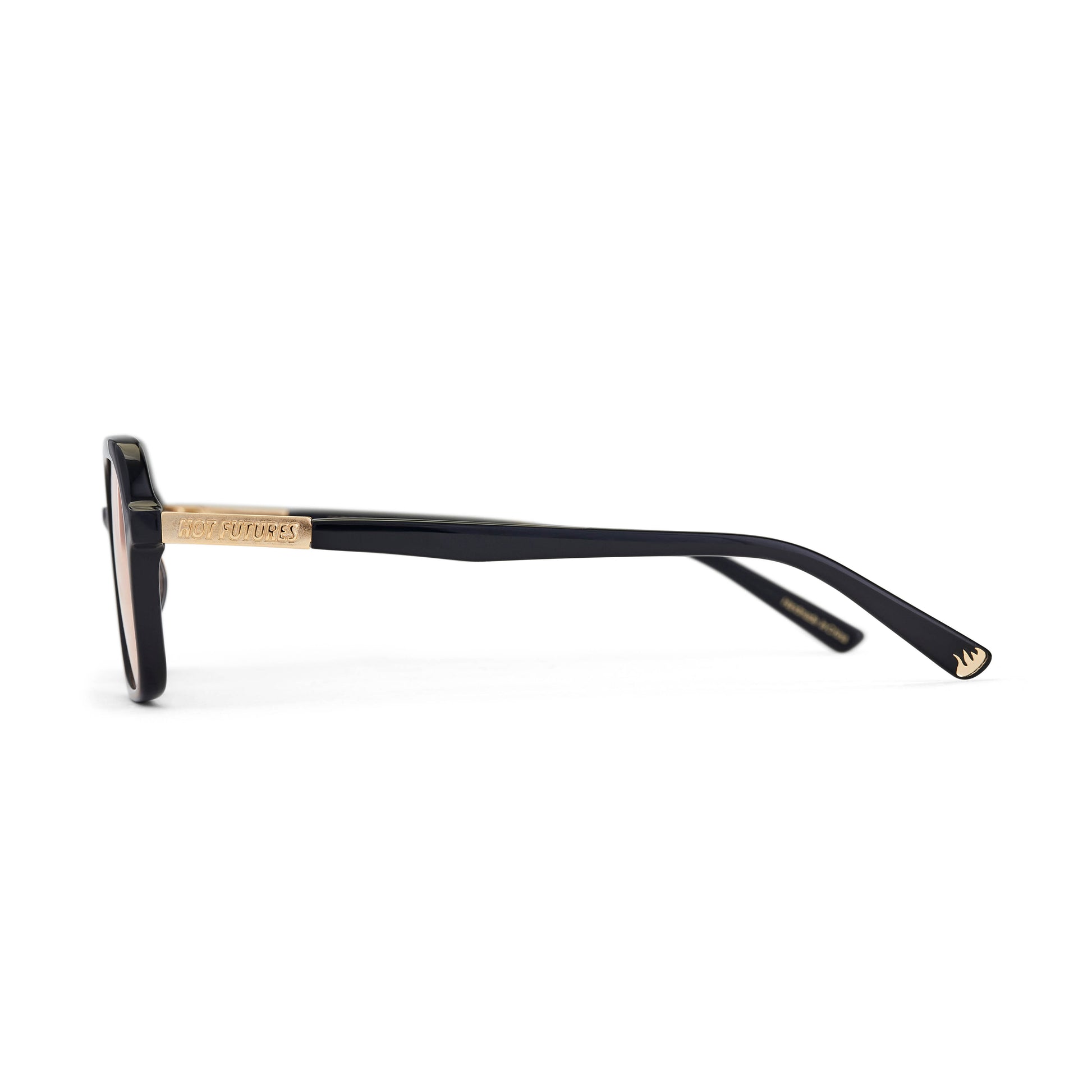 A side shot of the Dime slim rectangular aviator sunglasses with a black frame and amber tinted lenses. Showing the gold Hot Futures logo text branding on the sides