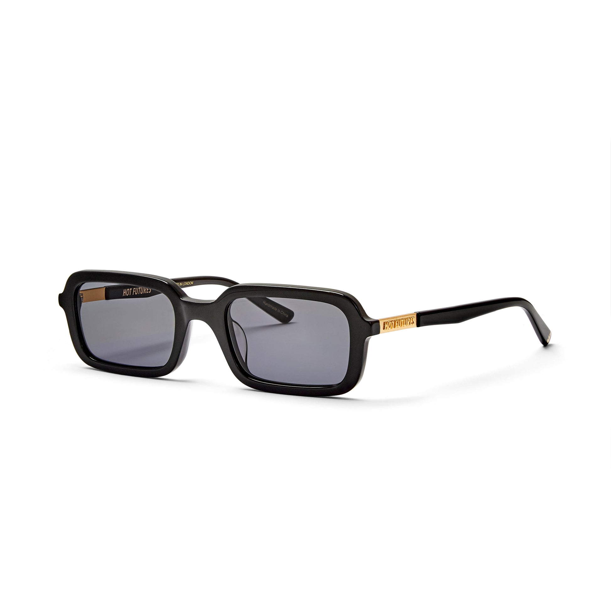 A pair of black rectangular sunglasses with smoke tinted lenses, designed in London and handmade in China.