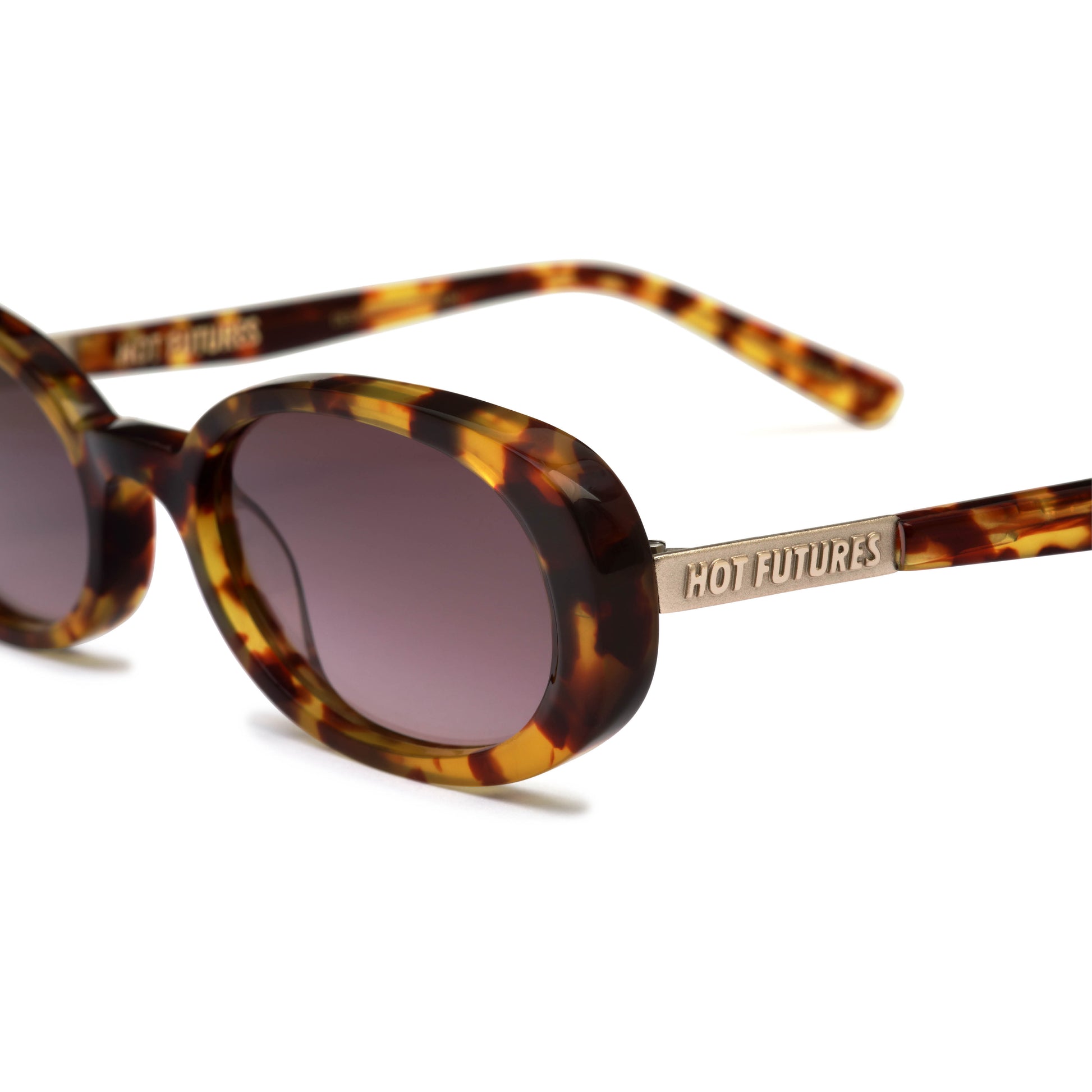 A pair of sunglasses with a classic tortoiseshell pattern and tan gradient lenses.