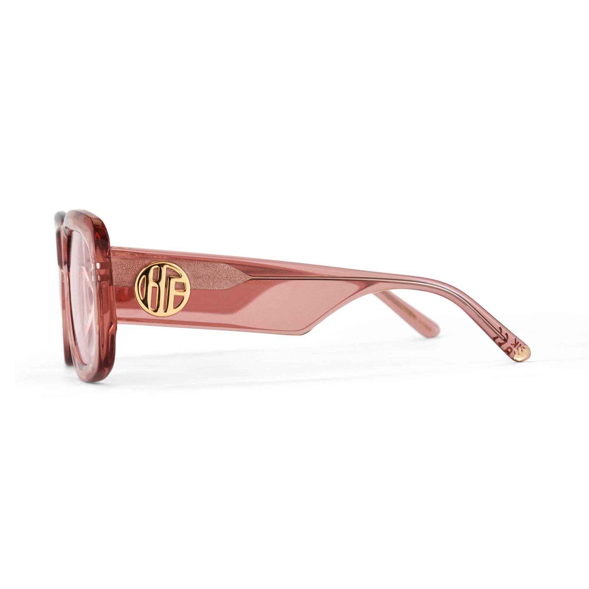 A pair of rose pink acetate flat top large sunglasses with pink tinted lenses, with the gold Hot Futures branding shown on the arms