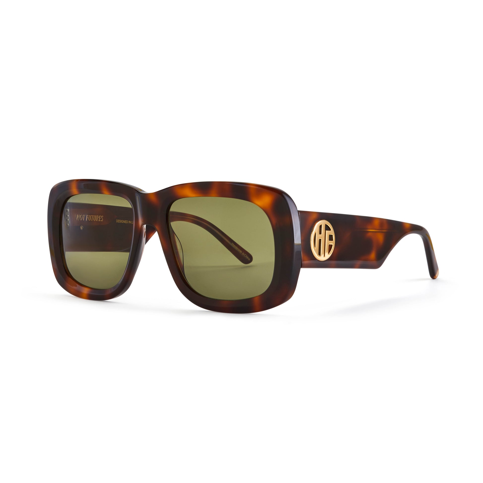 A pair of flat top acetate frame sunglasses with green tinted lenses and tortoiseshell pattern frame detailing. With gold Hot Futures logo branding to the arms