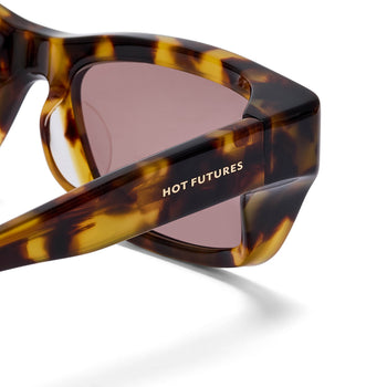 Sunglasses with tortoiseshell frame and 'Hot Futures' branding on a white background