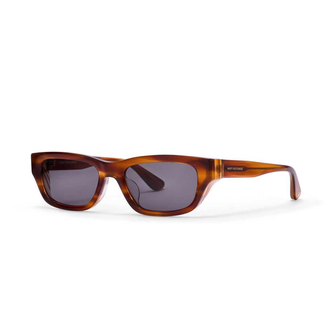 Dove sunglasses in caramel with dark green lenses by Hot Futures against a white backdrop