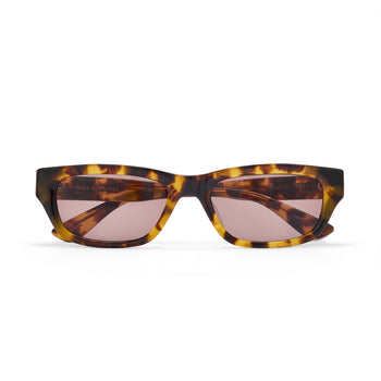 Tortoiseshell sunglasses with pink lenses on a white background