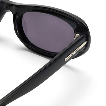 Black sunglasses with a visible brand logo on a white background