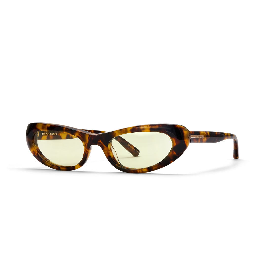 Sunglasses with tortoiseshell frame and yellow-tinted lenses on a white background