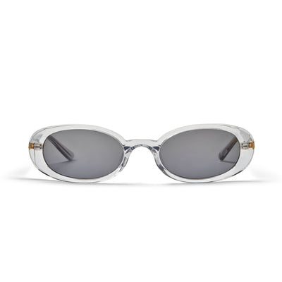 A pair of oval-shaped sunglasses with a clear acetate frame and smoke-coloured lenses.