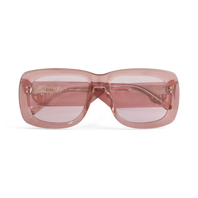 A pair of rose pink acetate flat top large sunglasses with pink tinted lenses, with the gold Hot Futures branding shown on the arms