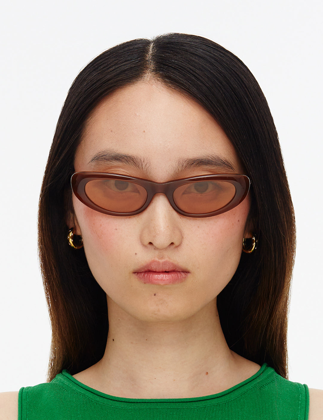 Sunglasses with brown frame and yellow lenses on a white background