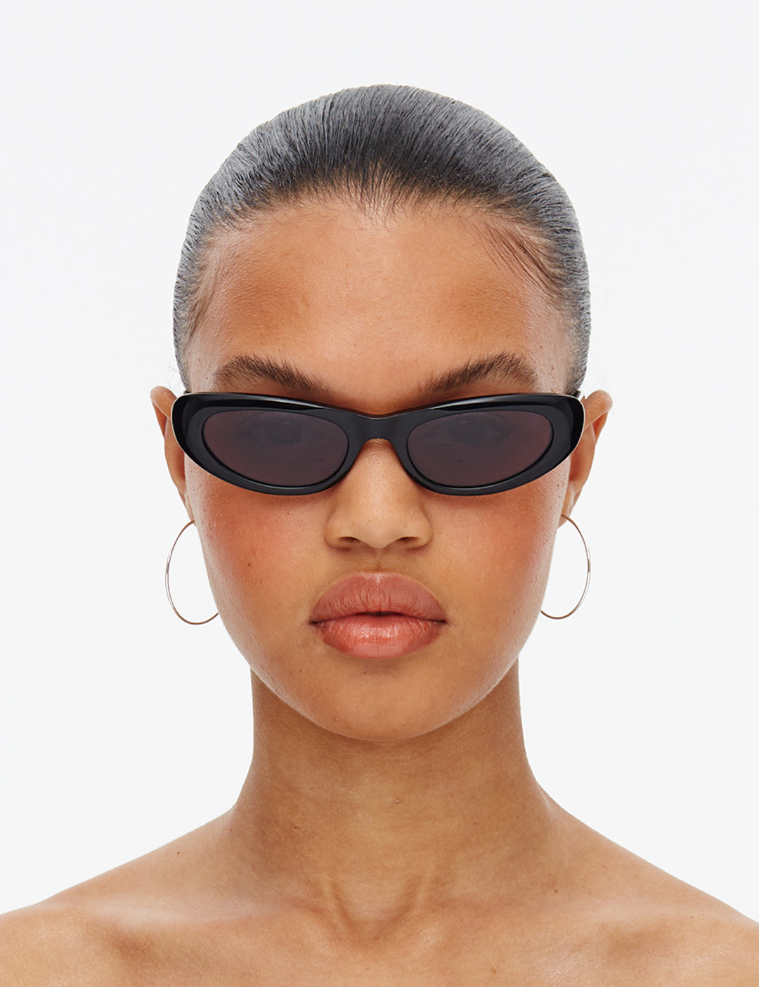 Black cat-eye sunglasses with dark smoky lenses on a white background