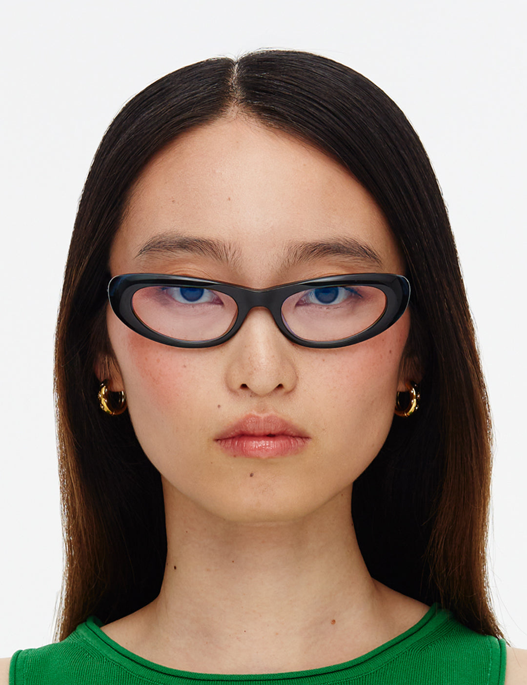 Deep green cat-eye glasses on a white background